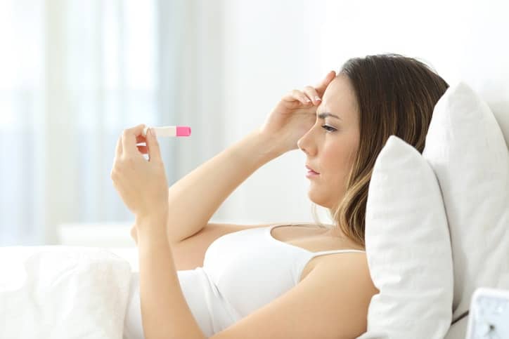 woman holding a pregnancy test