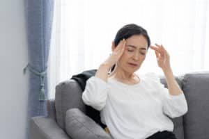 Asian middle aged woman who is sick